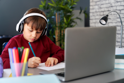 concentrated-boy-doing-homework-while-e-learning-XNXLCJB.png